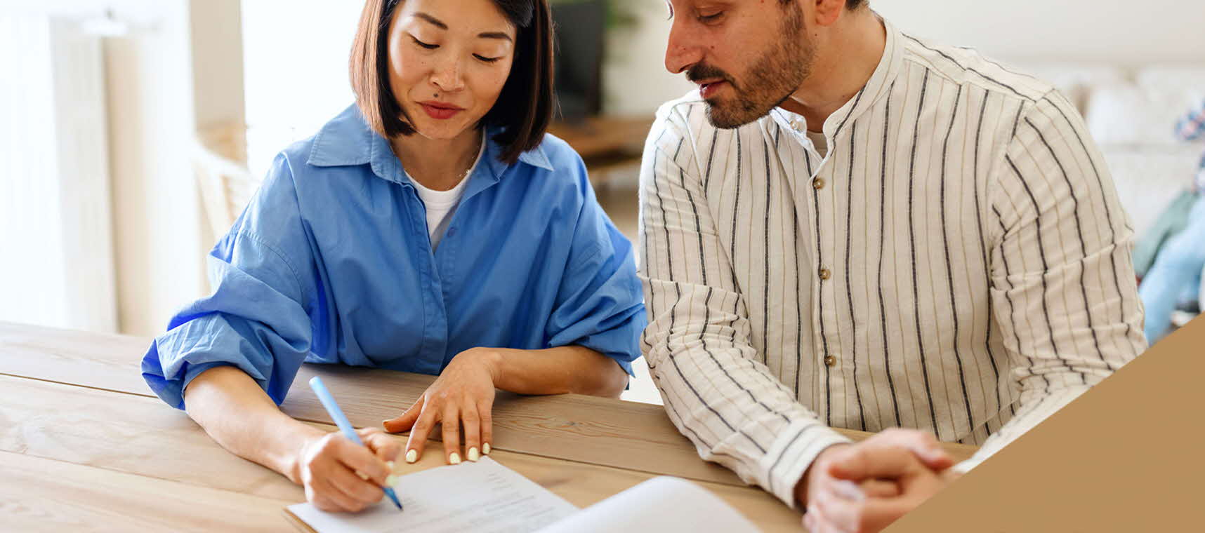 A couple in their 30s studying some documents.