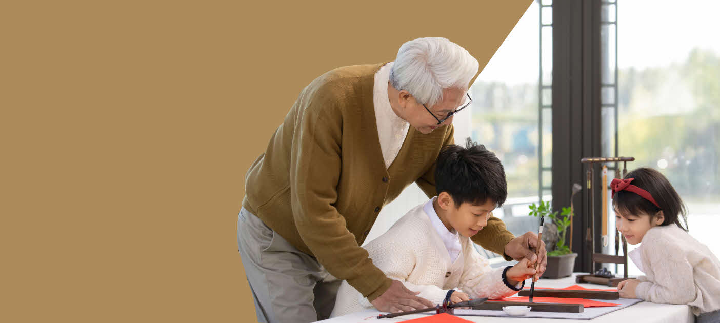 Grandpa passing on his knowledge of calligraphy to his grandson and granddaughter, as a metaphor for wealth and time-tested values.